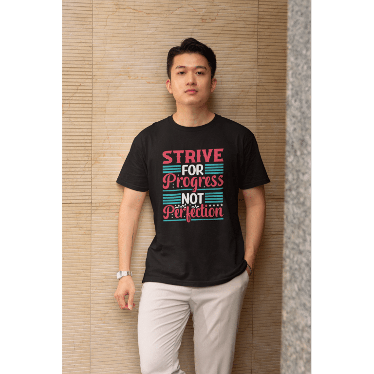 Unisex garment-dyed heavyweight t-shirt with "Strive For Progress Not Perfection" print - 100% ring-spun cotton, relaxed fit, progress mantra.