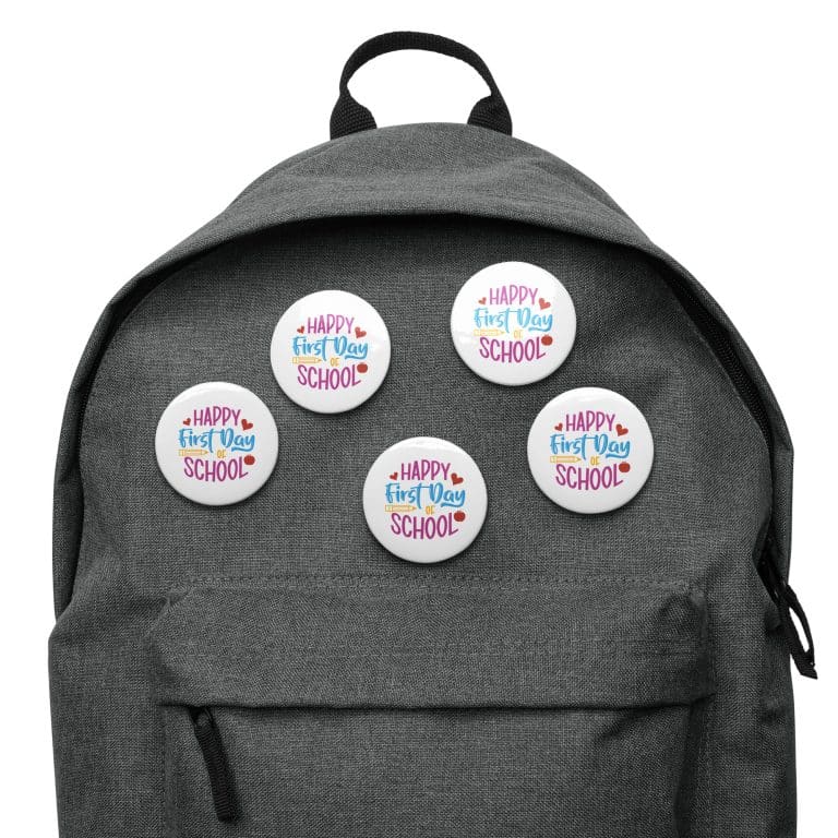 Set of 5 glossy pin buttons featuring "Happy First Day of School" design, durable tinplate, scratch & UV-resistant, perfect for backpacks.