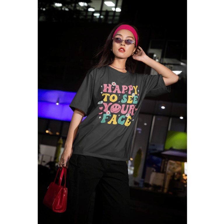 Oversized faded t-shirt with "Happy To See Your Face" graphic, garment-dyed cotton, relaxed fit, dropped shoulders