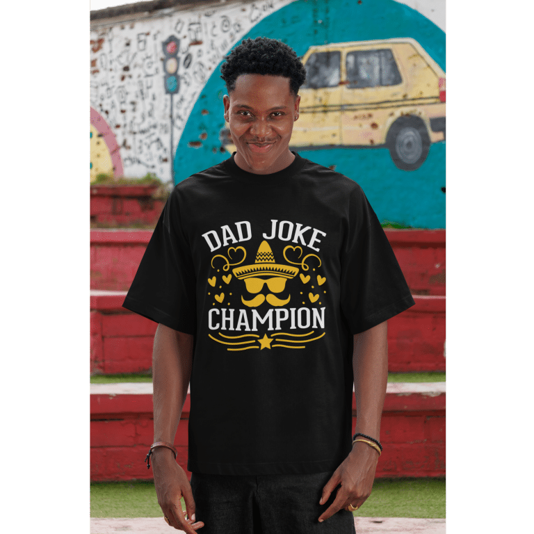 Oversized faded t-shirt with "Dad Joke Champion" graphic, loose boxy fit, 100% cotton, casual style.