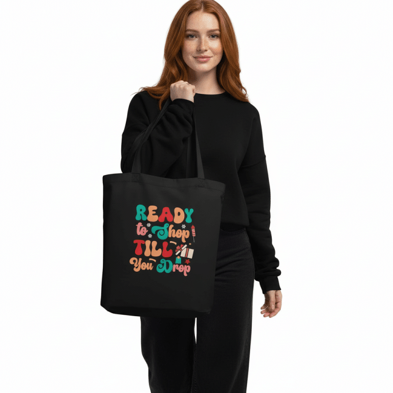 Organic cotton tote bag with "Ready to Shop Till You Drop" design, spacious 16"x14.5", 30lb capacity.