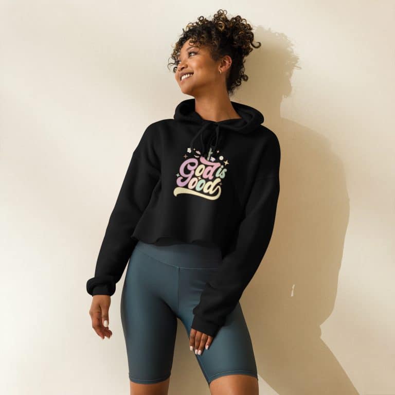 Black crop hoodie with 'God Is Good' pastel design, raw hem, and dropped shoulders - Bella + Canvas