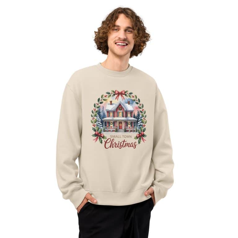 Oversized heavyweight sweatshirt in cream with vintage small town Christmas illustration, cozy unisex holiday style.