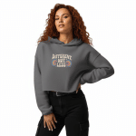 Charcoal gray crop hoodie with "Different Not Less" graphic, raw hem, and cozy fabric, perfect for stylish casual wear.