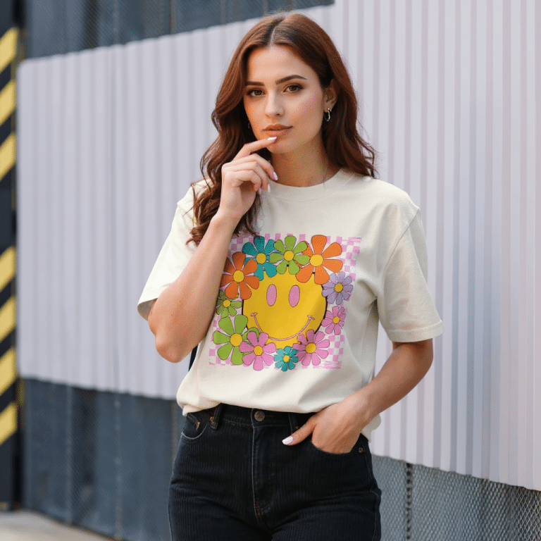 Oversized faded t-shirt featuring a smiley face design in vibrant colors, crafted from 100% carded cotton for comfort and style.