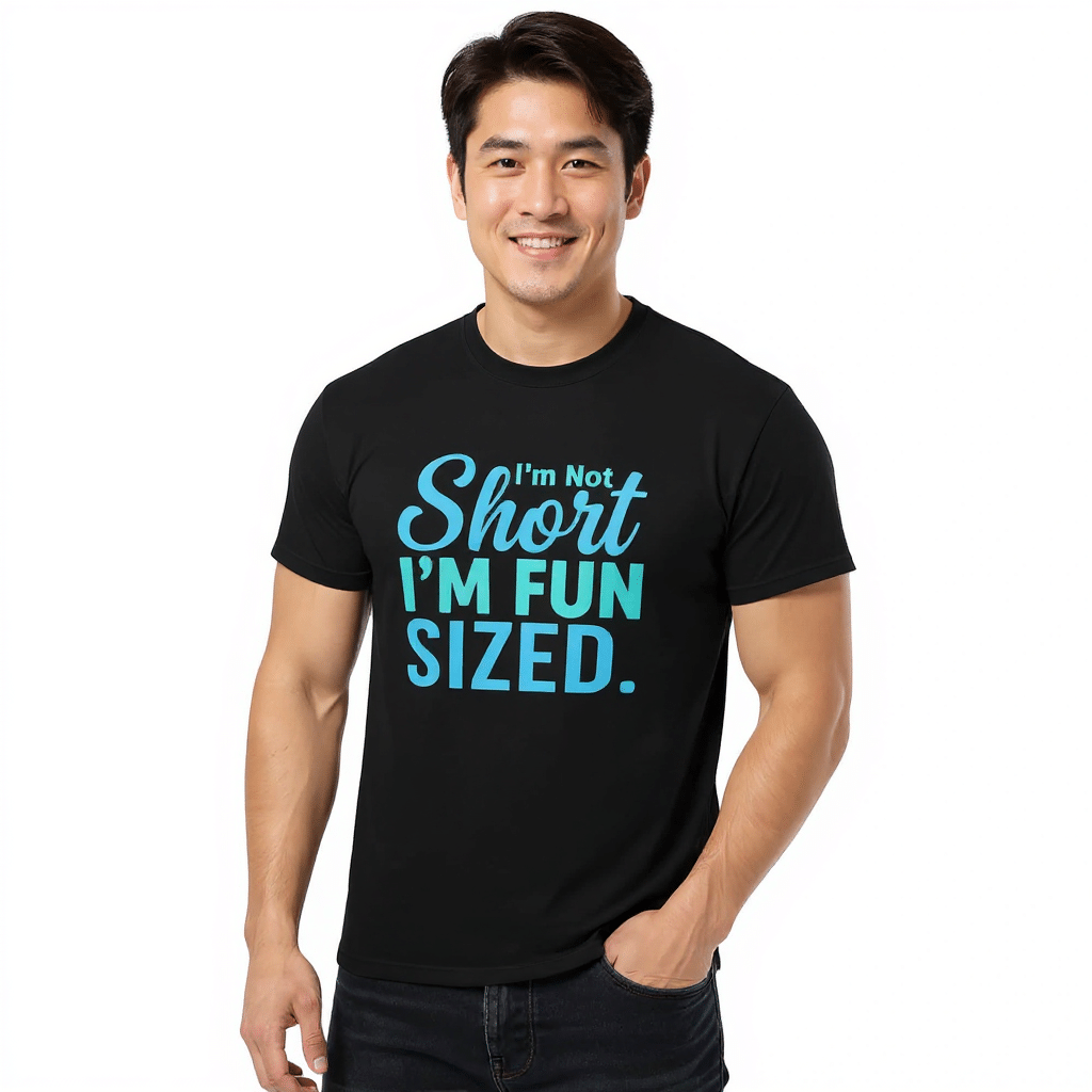 Unisex classic tee in Sport Grey with "I'm Not Short I'm Fun Sized" graphic, made of 100% cotton for a trendy streetwear look.