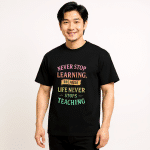Men’s box tee in black with "Never Stop Learning" print, oversized fit, drop shoulder sleeves, and ribbed collar. Perfect for streetwear.