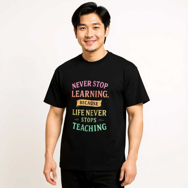 Men’s box tee in black with "Never Stop Learning" print, oversized fit, drop shoulder sleeves, and ribbed collar. Perfect for streetwear.